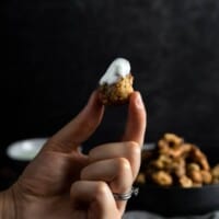 holding a fried morel mushroom that was dipped in a lemon Crema
