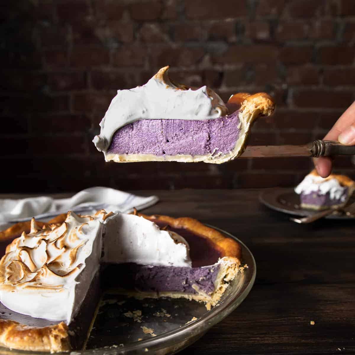 A slice of purple sweet potato pie being lifted on a pie server