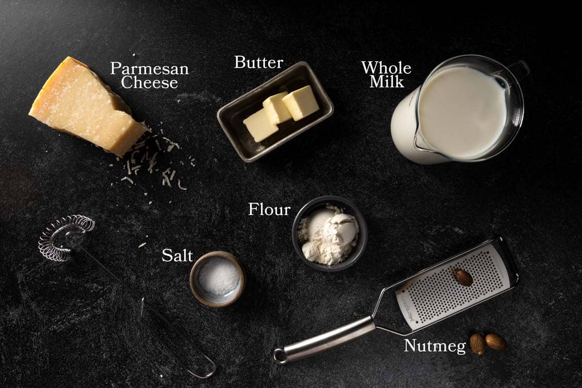 Ingredients needed for Parmesan Besciamella including Parmesan cheese, milk, butter, flour salt and nutmeg.