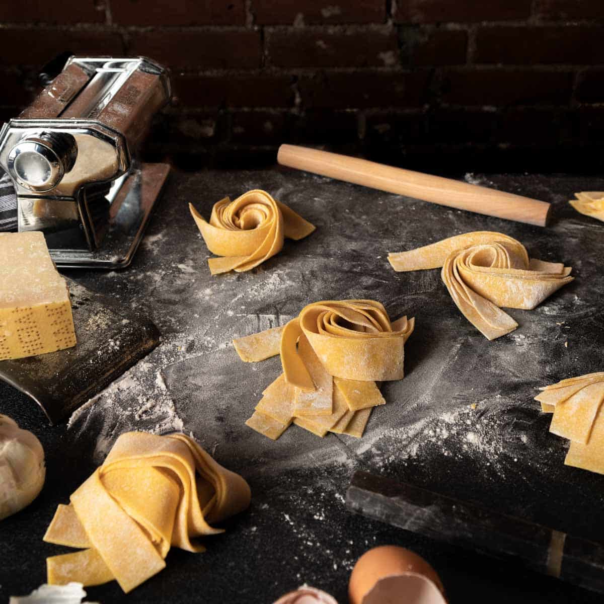 Several spiraled nests of homemade pappardelle pasta noodles. 