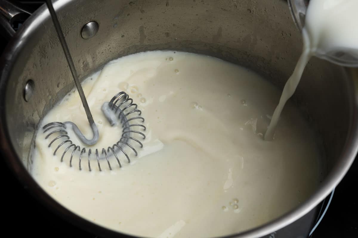 streaming milk into the roux