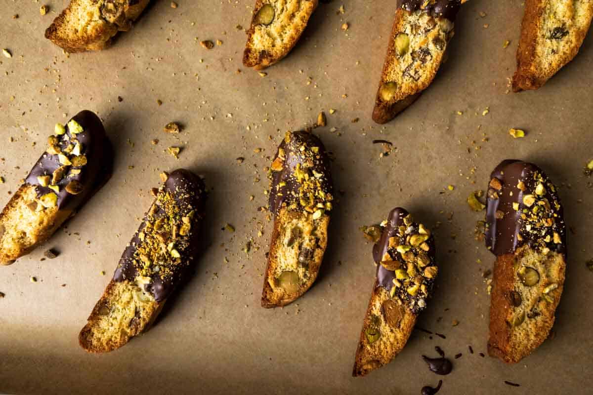 A tray full of chocolate dipped pistachio biscotti