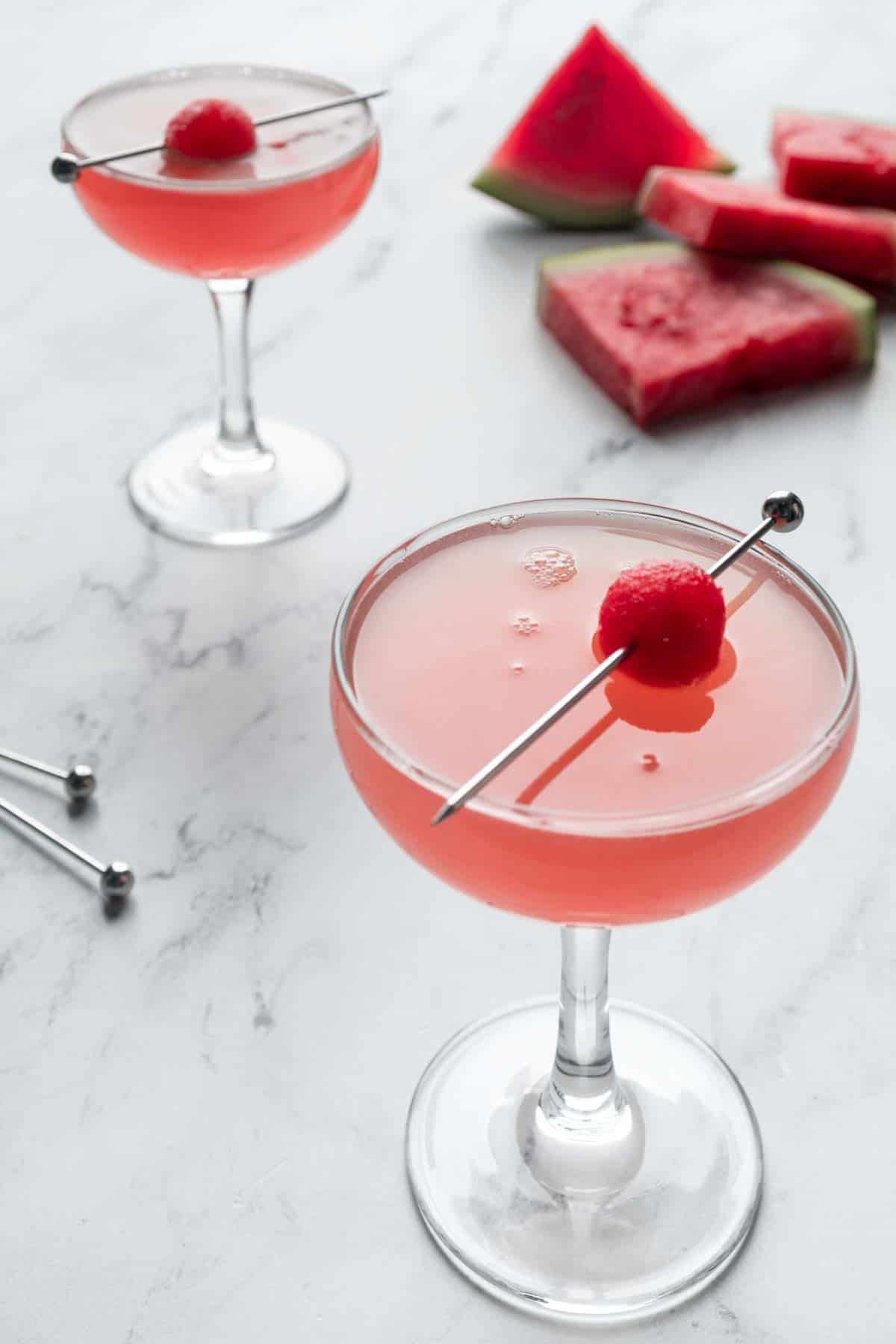 Two watermelon martinis and fresh watermelon wedges