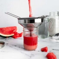 A jar filled with watermelon juice and sugar