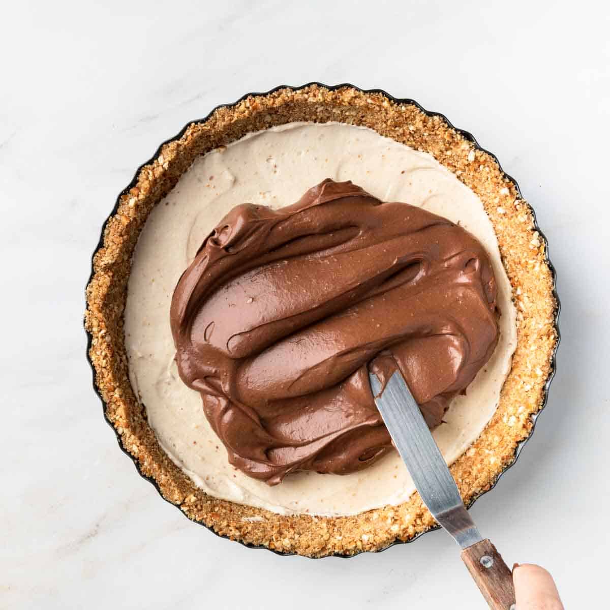 Spreading the chocolate mousse over the peanut butter layer
