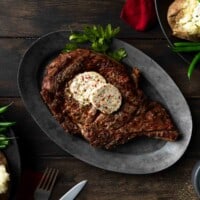 A perfectly grilled ribeye steak topped with butter