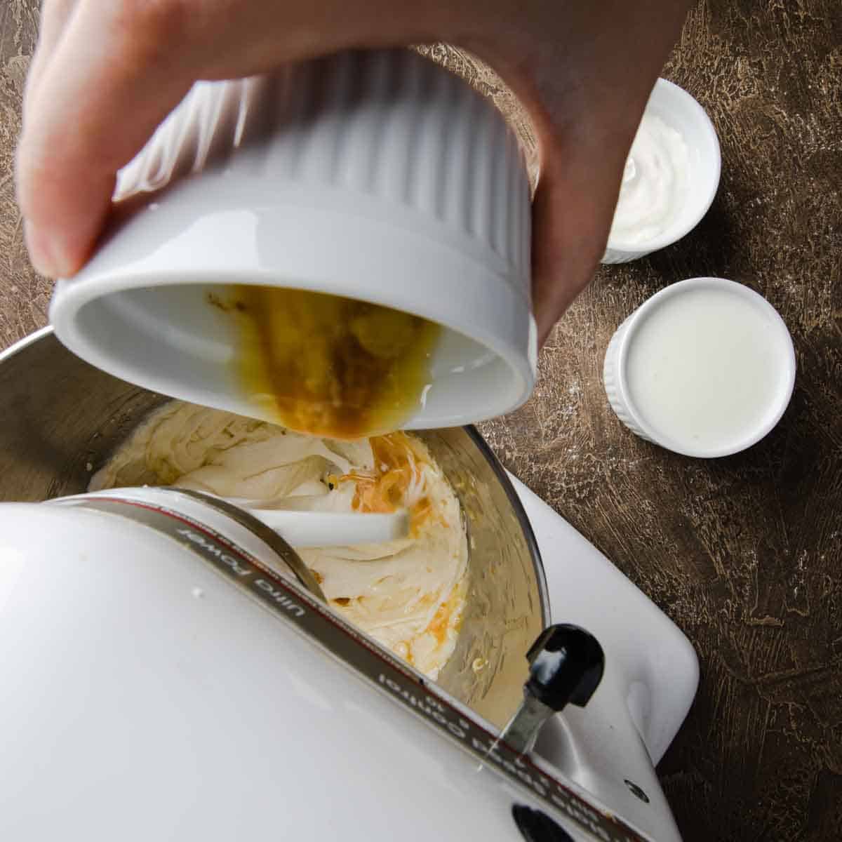 Pouring melted butter and sour cream into the batter