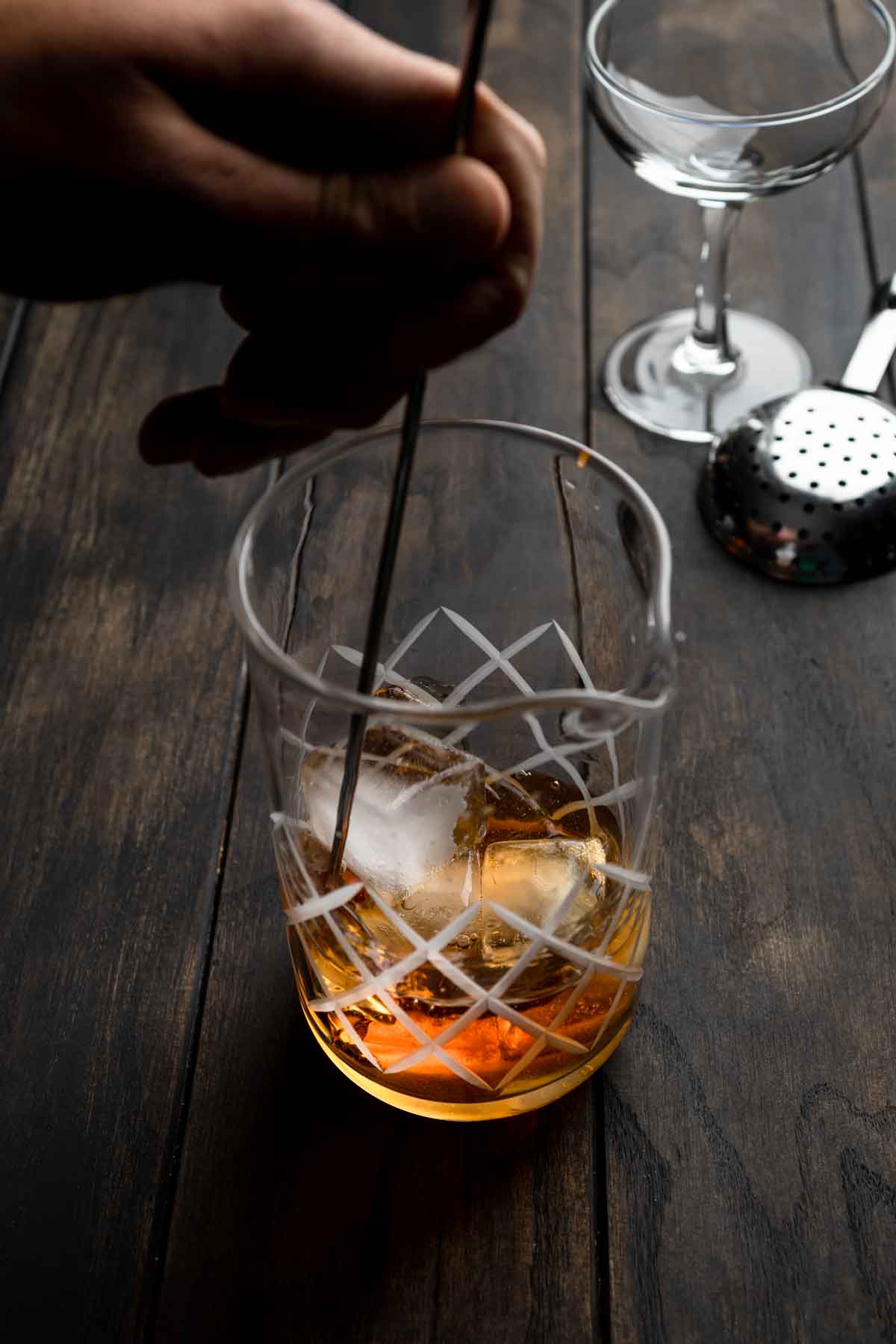 A Manhattan cocktail being stirred with ice in a yari