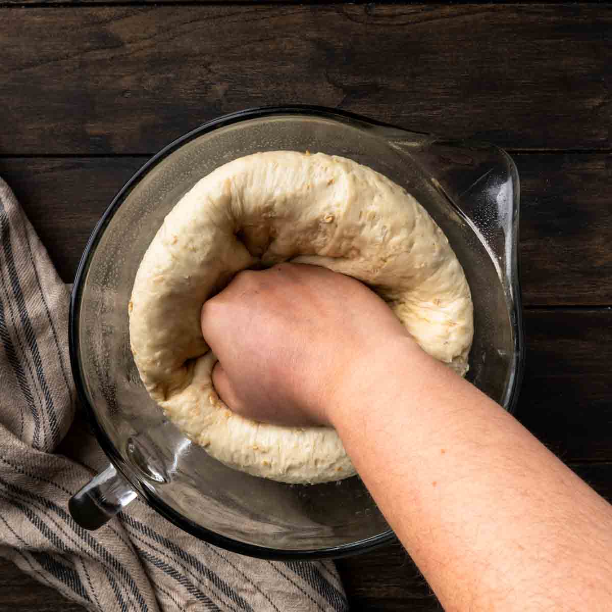 Punching down the dough to deflate